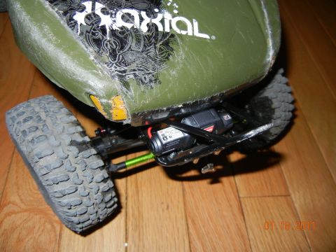 1996 Ford Bronco - Close-up of a green remote control car body, showing the 'Axial' logo and internal electronics.