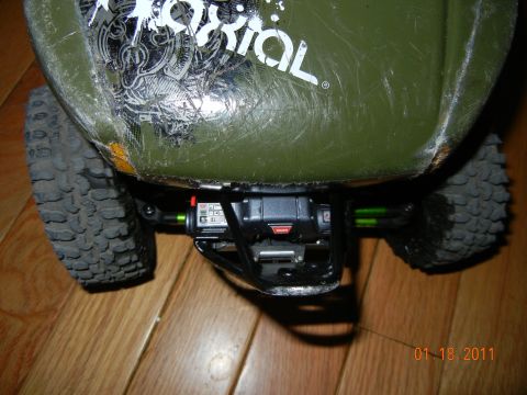 1996 Ford Bronco - RC car rear axle detail with visible shock absorber and green springs.