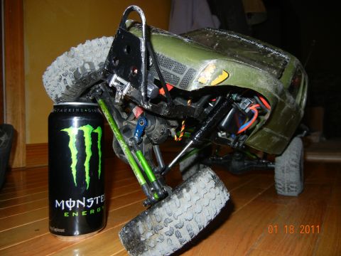 1996 Ford Bronco - A remote-controlled rock crawler is shown next to a can of Monster Energy drink, highlighting its size.