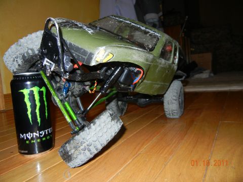 1996 Ford Bronco - A remote control rock crawler is shown next to a Monster Energy drink can, highlighting its scale.