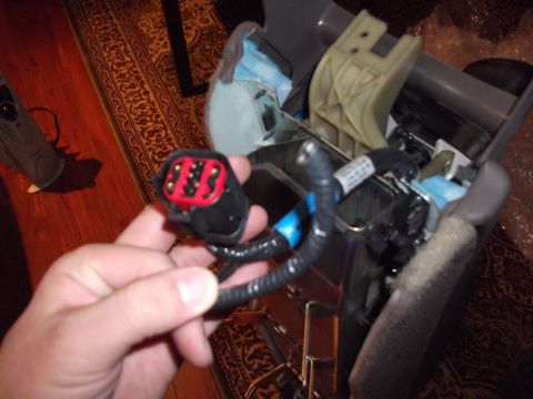 1998 Ford Crown Victoria - Close-up of a vehicle wiring harness connector being held.