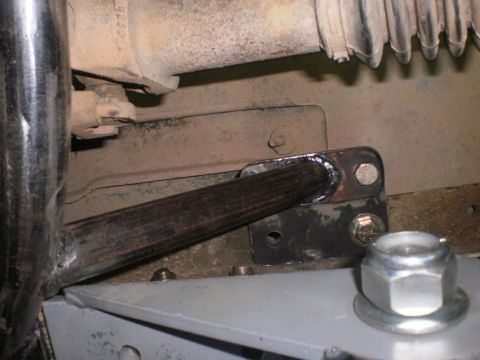 1995 Ford Bronco - Close-up view of a vehicle's undercarriage, focusing on a metal bracket and bolts.