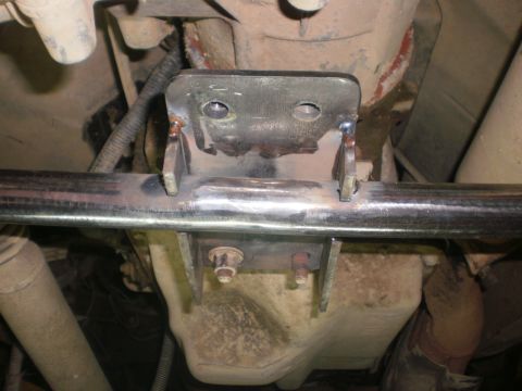 1995 Ford Bronco - Close-up of a vehicle's undercarriage, showing a fabricated metal bracket attached to the crossmember.