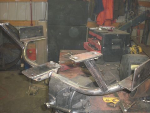 1995 Ford Bronco - A custom metal frame is clamped in a vise, likely for fabrication or repair.