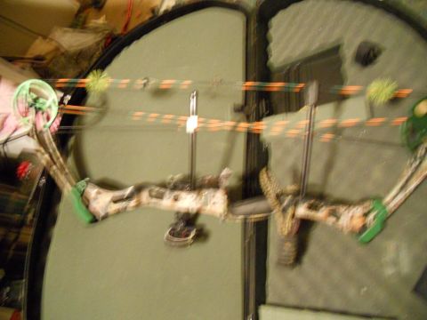 1992 Jeep Cherokee - Compound bow with camouflage riser and orange/green string is shown inside its case.