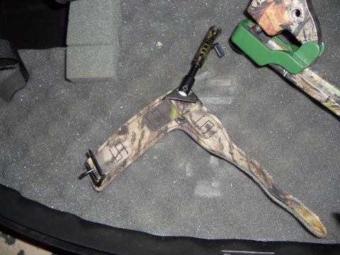 1992 Jeep Cherokee - A camouflage bow sling and part of a compound bow are shown resting on foam padding inside a case.