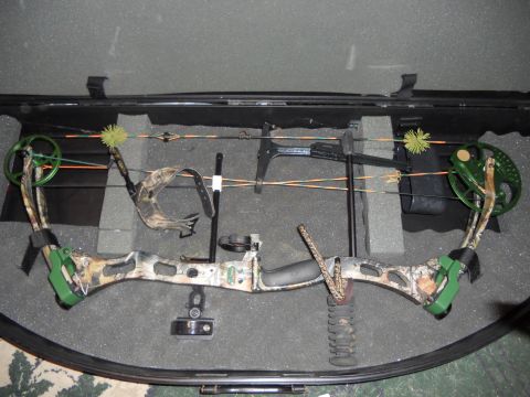 1992 Jeep Cherokee - A compound bow, green accents and a camouflage finish, is stored inside its protective case.