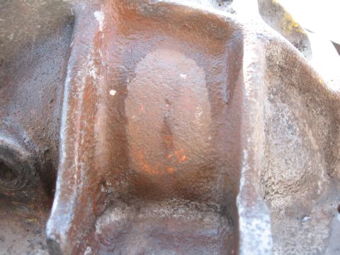 1968 Shelby GT500 - This is a close-up view of a cast iron differential housing, showing its textured surface and signs of rust.