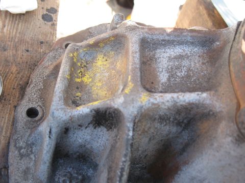 1968 Shelby GT500 - This is a close-up view of a cast iron differential housing, showing its textured surface and some yellow paint markings.