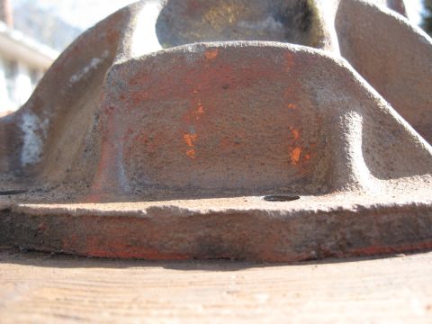 1968 Shelby GT500 - Close-up of a cast iron differential housing, showing signs of wear and remnants of orange paint.