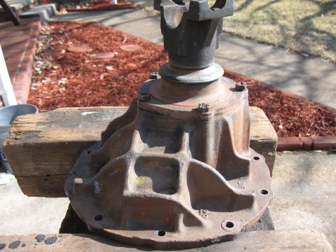 1968 Shelby GT500 - Differential housing part shown resting on wooden blocks outdoors.
