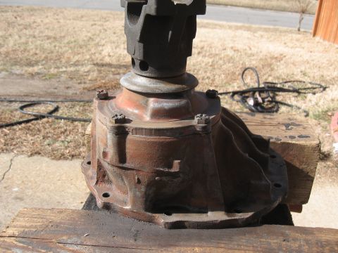1968 Shelby GT500 - A rusty differential housing is shown, resting on wooden blocks outdoors.