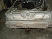 1985 Chevrolet Camaro - The rear section of a car body is shown, stripped down and awaiting restoration or repair.