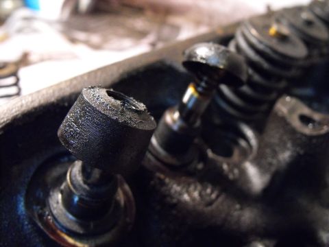 1982 Chrysler New Yorker - There's the ages old original Mopar valve seals. The intake closest to us, the exhaust furthest away. Clean and/or file the edge off the si…