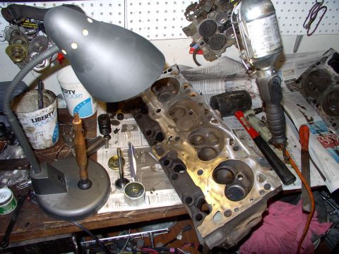 1982 Chrysler New Yorker - Here's my valve lapping station using the desk lamp. You can see the initial course lap on the exhaust seat in the first chamber.