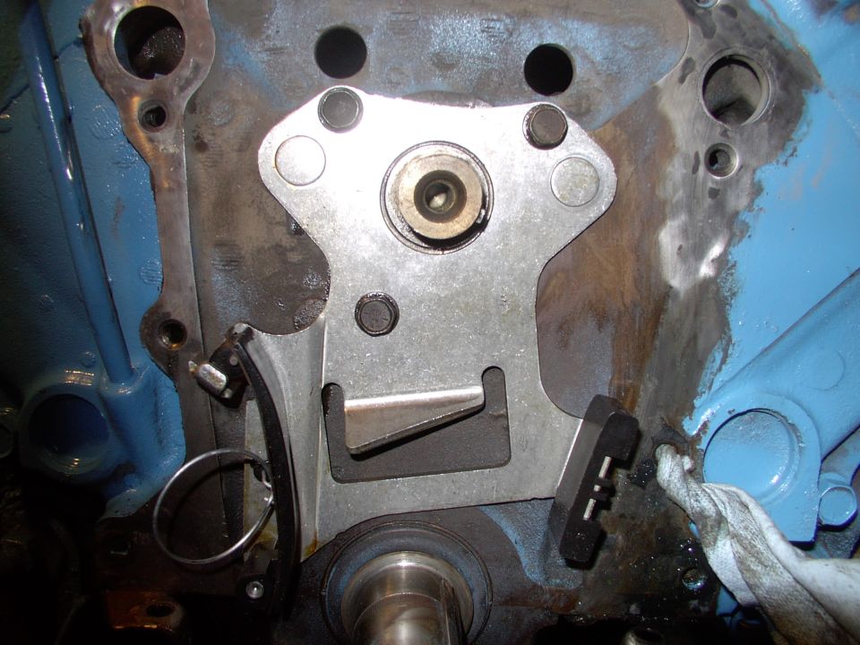 Oops you're done. Yes it's just three bolts and it replaces your original thrust plate and that little pointed tang just about the crank ensures oil flows onto the new chain.