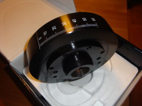 1989 Ford Bronco - A black crankshaft pulley with white timing marks is shown inside its packaging.