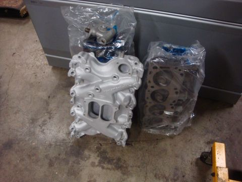 1989 Ford Bronco - Two engine components, an intake manifold and a cylinder head, are packaged for storage.