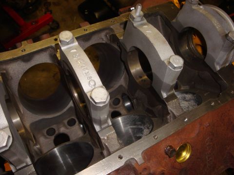 1989 Ford Bronco - Close-up view of an engine block's internal components, connecting rods and bolts. A part number is visible on one of the rods.