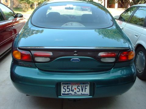1996 Ford Taurus - Rear view of a teal 1996 Ford Taurus, showing its distinctive taillights and Ford badging.