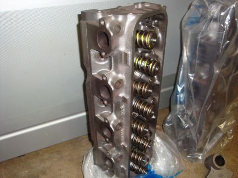 1989 Ford Bronco - Close-up of an engine cylinder head, showing internal components and exhaust/intake ports.