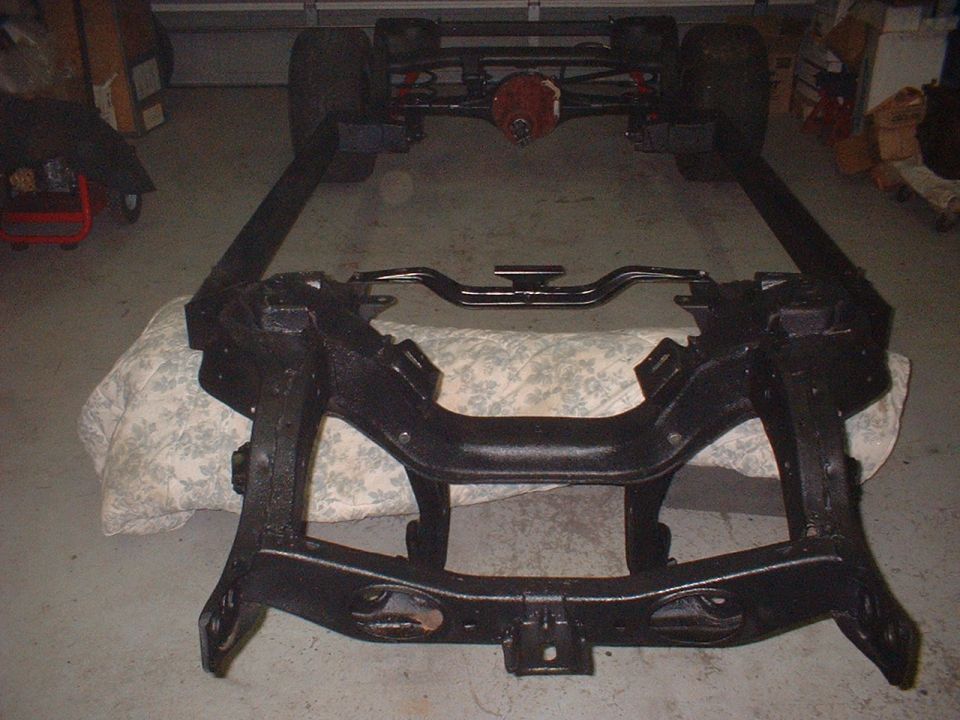 Car frame with rear axle and suspension components