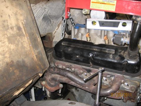 1961 International Scout 800 - Engine installation in progress, with an engine hoist supporting the motor.