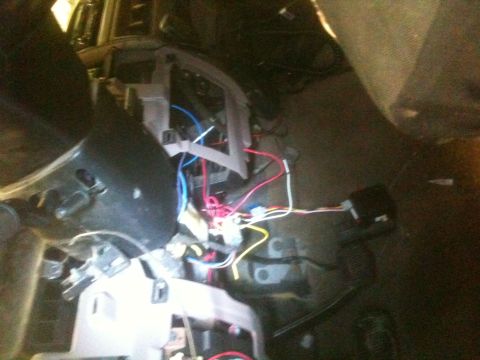 1993 Ford Bronco - The interior of a vehicle shows a complex network of exposed wires and electronic components.