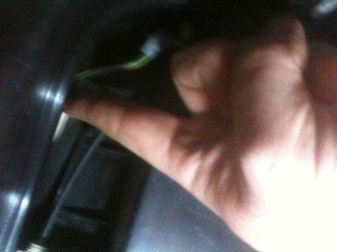1993 Ford Bronco - A hand is shown connecting a green wire to a component, likely part of an electronic installation.