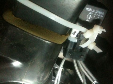 1993 Ford Bronco - Close-up of an automotive relay and its wiring harness, secured with zip ties.