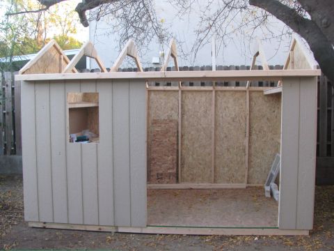 1968 Ford Mustang - A shed is being built, showing its framing and unfinished interior walls.