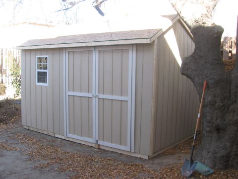 1968 Ford Mustang - Outdoor storage shed with a shovel and tree nearby.