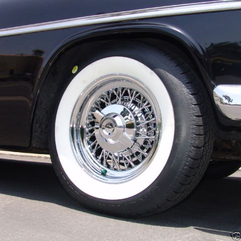 1991 Ford LTD Crown Victoria - Close-up of a chrome wire wheel and whitewall tire on a classic black car.
