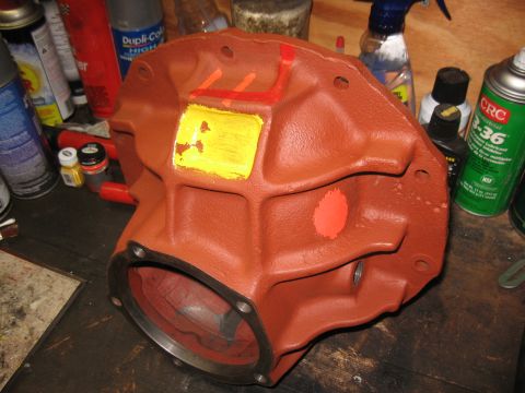 1968 Shelby GT500 - A painted differential housing sits on a workbench surrounded by various automotive spray cans and bottles.