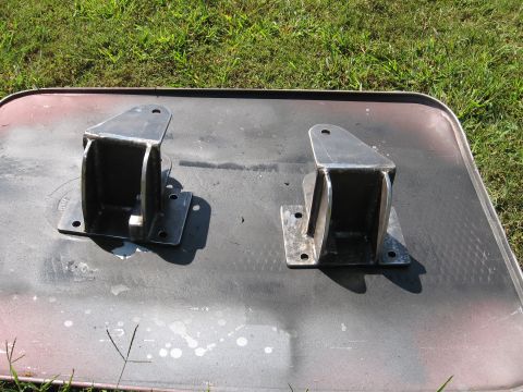 1995 Ford F-150 - Two custom metal brackets are shown resting on a surface, with a Supermotors.net logo visible.