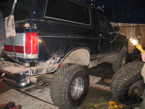 1989 Ford Bronco - This 1989 Ford Bronco is seen from the rear, equipped with oversized tires and a shovel attached to the spare tire carrier.
