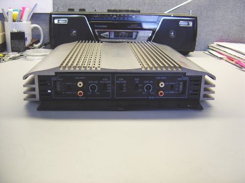 1986 Ford Bronco - A car audio amplifier and a boombox are placed on a desk.