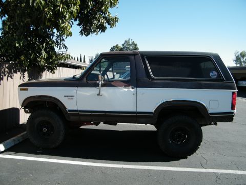 1982 Ford Bronco - Side view of a two-tone brown and white Ford Bronco.