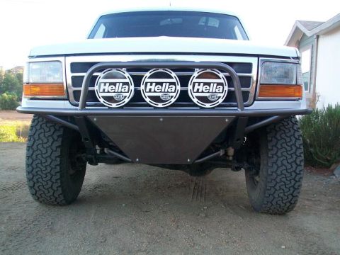 1982 Ford Bronco - Front view of a modified Ford truck, a custom bumper and auxiliary lighting.