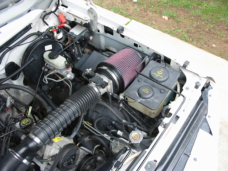 Ford Bronco engine bay with red cone air filter and black intake ductwork