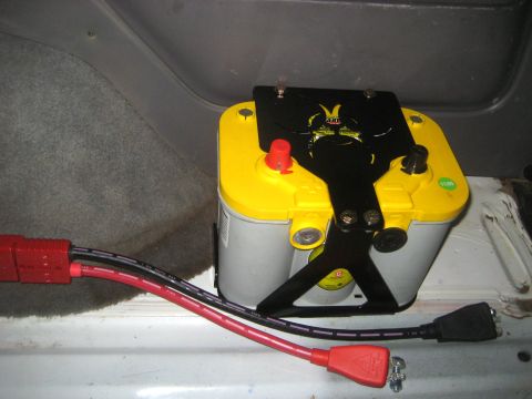 1996 Ford Bronco - A yellow and silver Optima YellowTop battery is mounted inside a vehicle with red and black power cables attached.