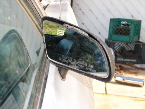 1973 Ford Ranchero - Objects in mirror are closer than they appear, reflecting the interior and a fence.