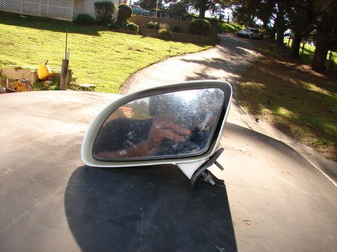 1973 Ford Ranchero - Side mirror removed from a vehicle, showing a reflection of the photographer.