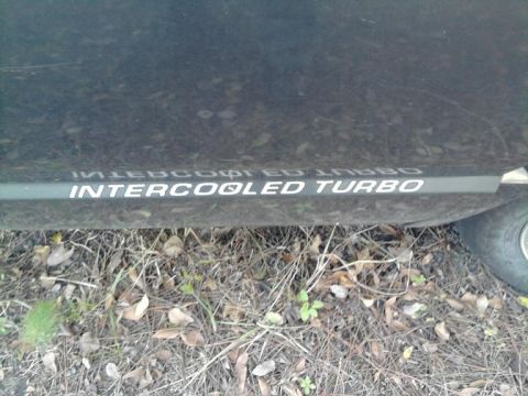 1989 Dodge Caravan - The side panel of a vehicle displays "INTERCOOLED TURBO" text.