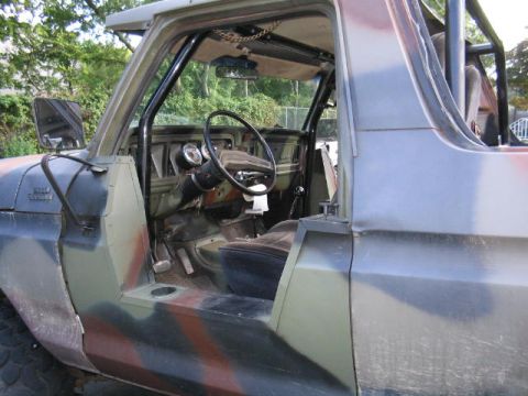 1979 Ford Bronco - The interior of a 1979 Ford Bronco shows a roll cage and aftermarket gauges.