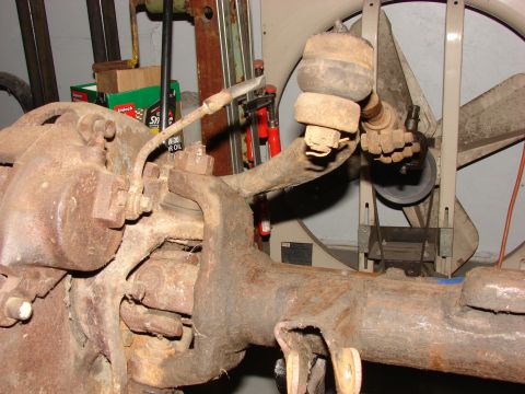 1971 International School Bus - Rusty vehicle suspension part shown in detail, likely from an older truck or heavy equipment.