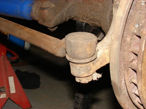 1971 International School Bus - This photo shows a close-up view of a vehicle's steering linkage, including a tie rod end and ball joint.
