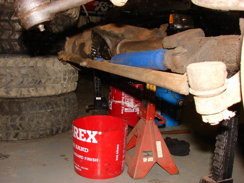 Vehicle undercarriage with differential, steering linkage, and tires, supported by jack stands