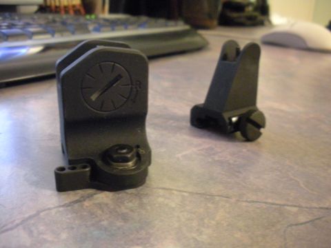 1996 Ford Bronco - Two black gun sights are visible on a desk, with a keyboard and mouse in the background.