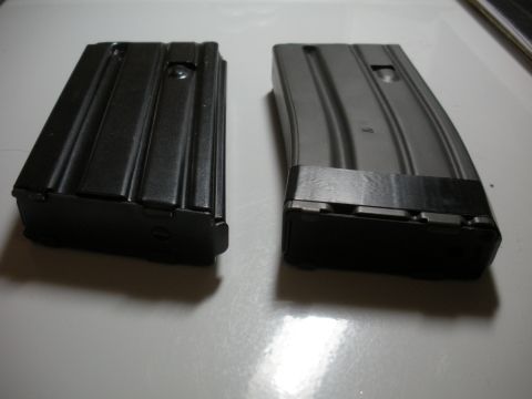 1996 Ford Bronco - Two rifle magazines are shown on a white surface, with a SuperMotors logo in the lower right corner.